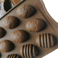 Brown silicone egg mold cavity close-up with embossed Easter egg designs