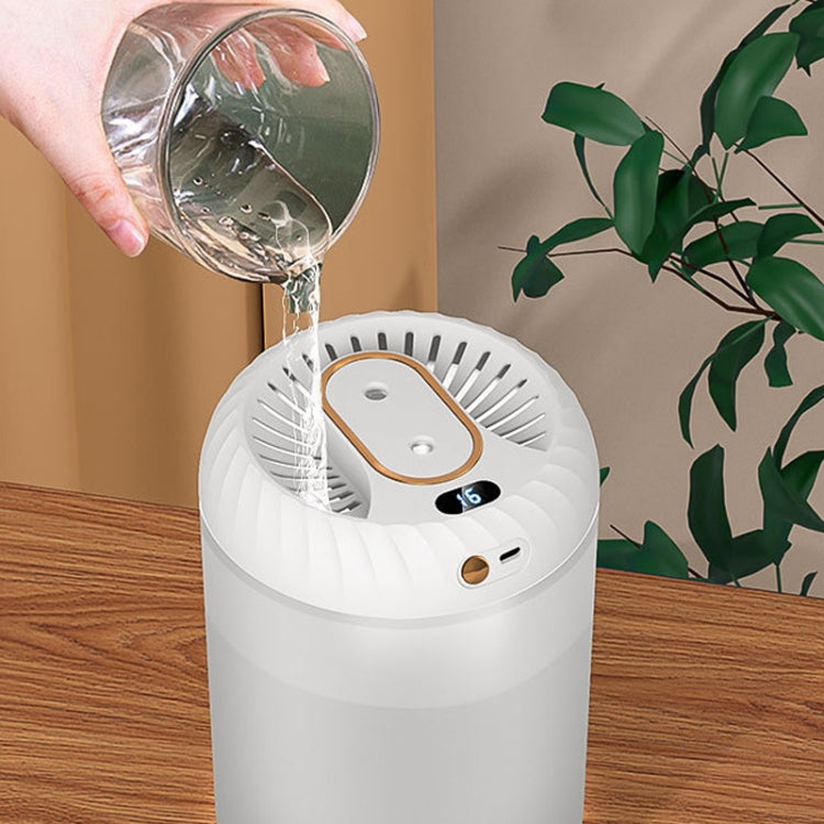 White humidifier with top opening being filled from a glass cup