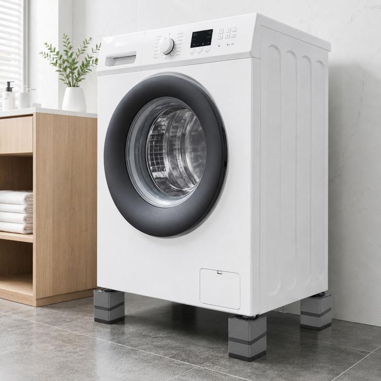 Washing machine sitting on four dark grey shock-absorbing floor pads