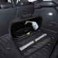 Black open charger storage bag laid flat inside a car trunk with mesh lining visible.