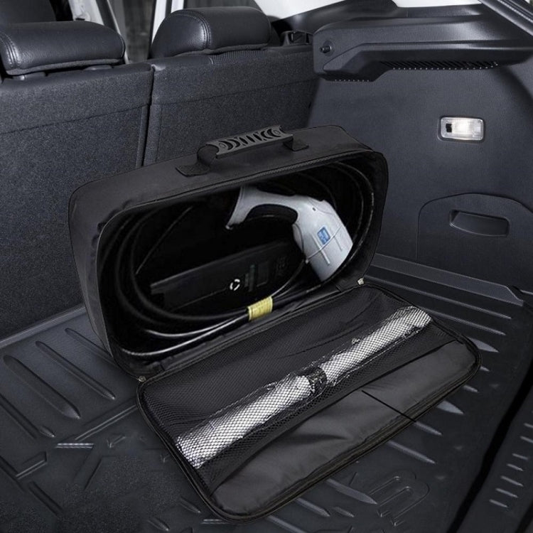 Black open charger storage bag laid flat inside a car trunk with mesh lining visible.