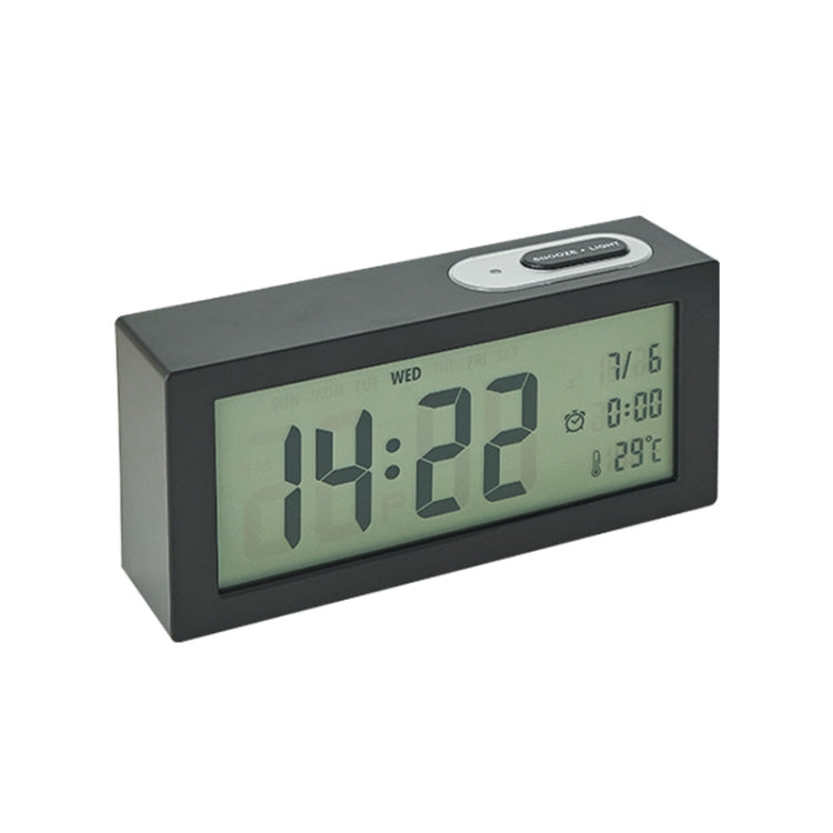 Black bedside digital alarm clock with green LCD time and date display