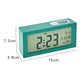Turquoise bedside digital alarm clock with green LCD and top control button