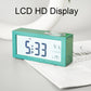 Turquoise digital alarm clock with large LCD display and top snooze/light button