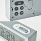 Gray digital alarm clock back panel with Alarm, Time Set, Reset, and volume buttons