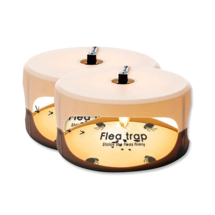 Two beige flea trap domes with lamp bulbs on top, shown from a side angle