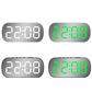 LED digital desk alarm clock shown in dark and light housings with green/white time