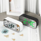 Black and white LED digital alarm clocks with green time displays on desktop