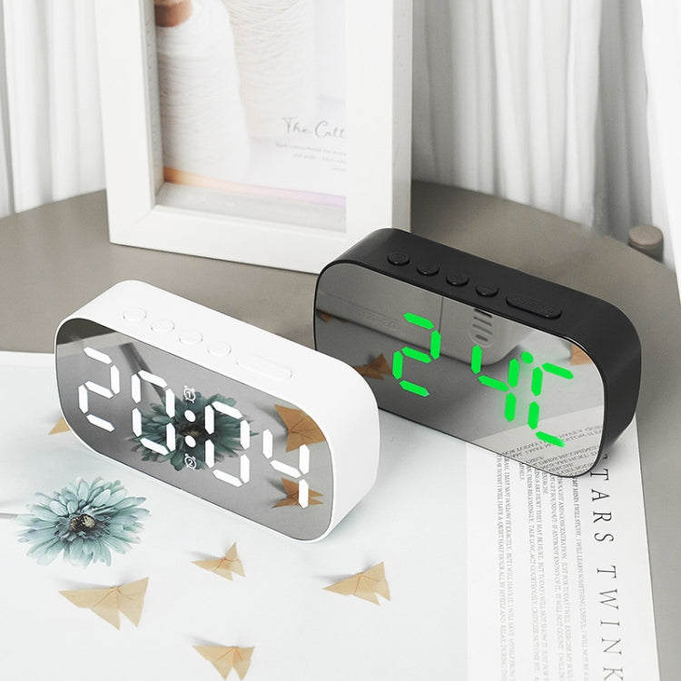 Black and white LED digital alarm clocks with green time displays on desktop