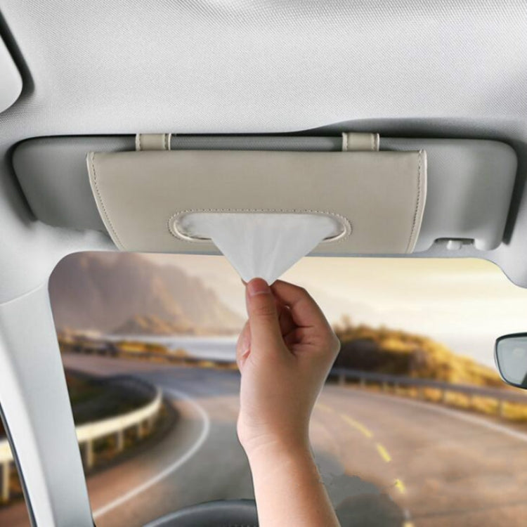 Beige car visor tissue holder with oval opening and tissue emerging
