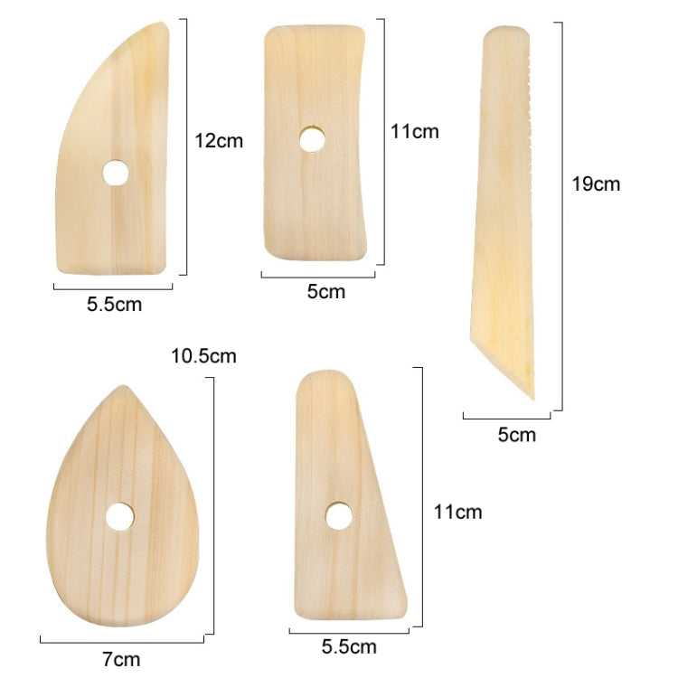 Five wooden pottery scraper shapes with round hanging holes and varied blades