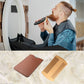 Man grooming beard with wooden comb; brown PU leather case beside it.
