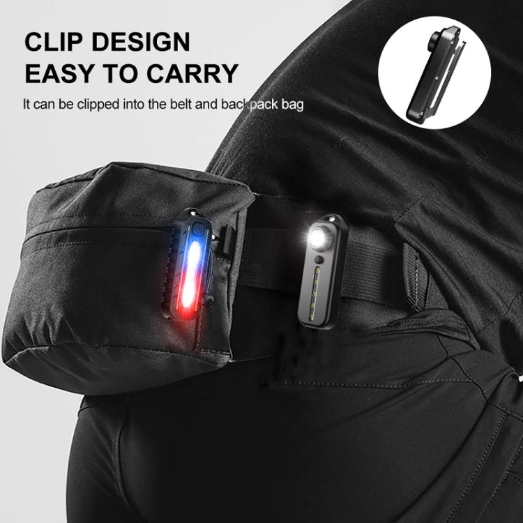 Clip-on black warning tail light with visible charging port, worn on a bag