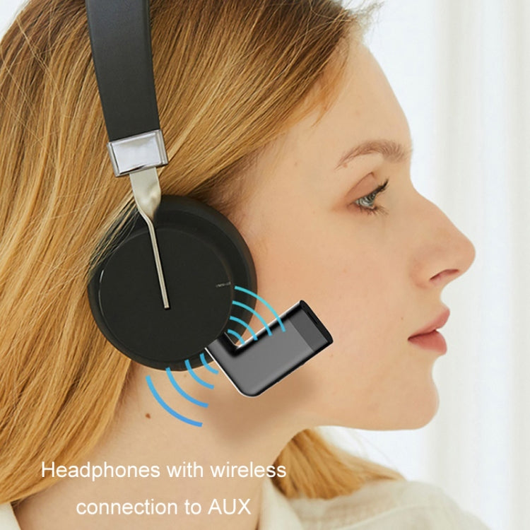 Black Bluetooth AUX audio adapter clipped for wireless music playback in car