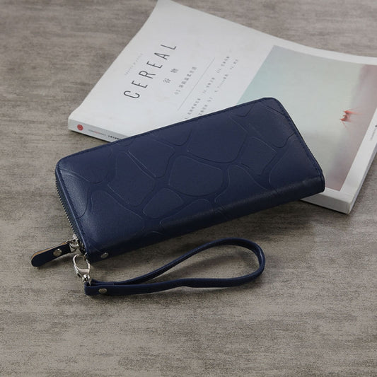 Blue zip-around long wallet with embossed stone-style pattern and wrist strap