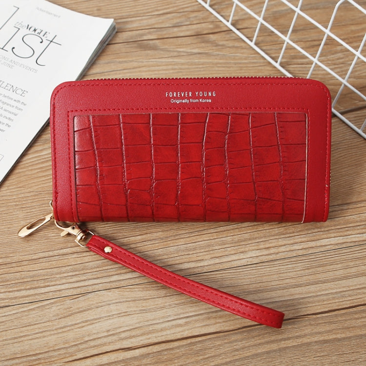Red crocodile-embossed long wallet with wrist strap and zip-around closure