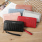 Set of croc-embossed zip wallets in red, black, pink, and light gray with wrist straps