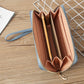Light blue long wallet opened to show card slots and interior zip compartment