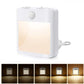 White plug-in motion sensor LED night light with warm light glow on front panel
