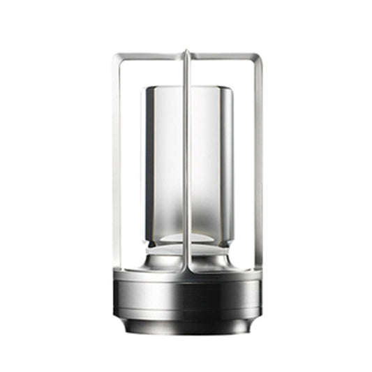 Silver cross-frame portable table lamp with clear acrylic light pillar and dark base