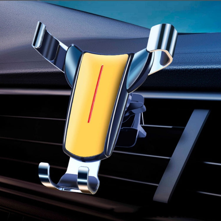 Yellow triangular gravity phone holder clipped to car air vent, chrome arms and base supports