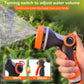 Orange and black garden watering sprinkler adjusting water volume while spraying