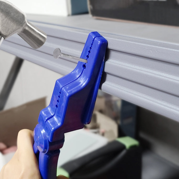 Blue nail fixing tool pressing nail into metal track with hammer
