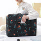 Black flamingo-pattern travel storage bag with front zipper pocket and handles