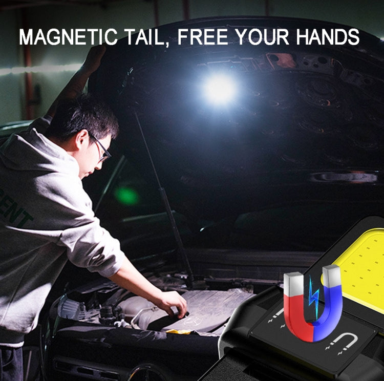 Mini black COB keychain flashlight shining near car engine components