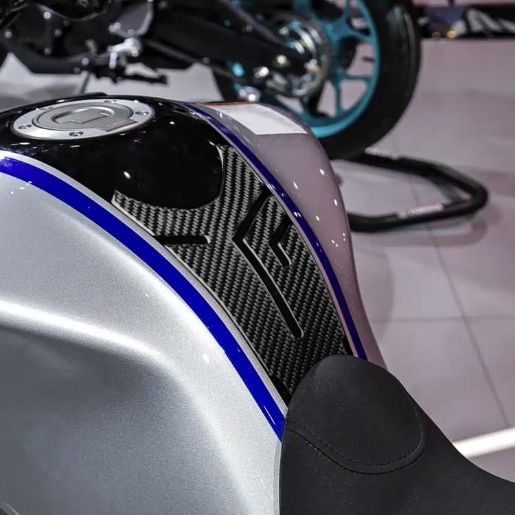 Motorcycle fuel tank decal with black carbon herringbone texture and blue trim lines