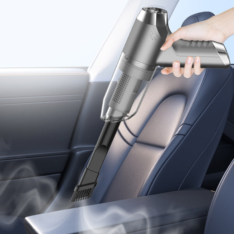 Handheld car vacuum being used on a car seat, nozzle cleaning detail
