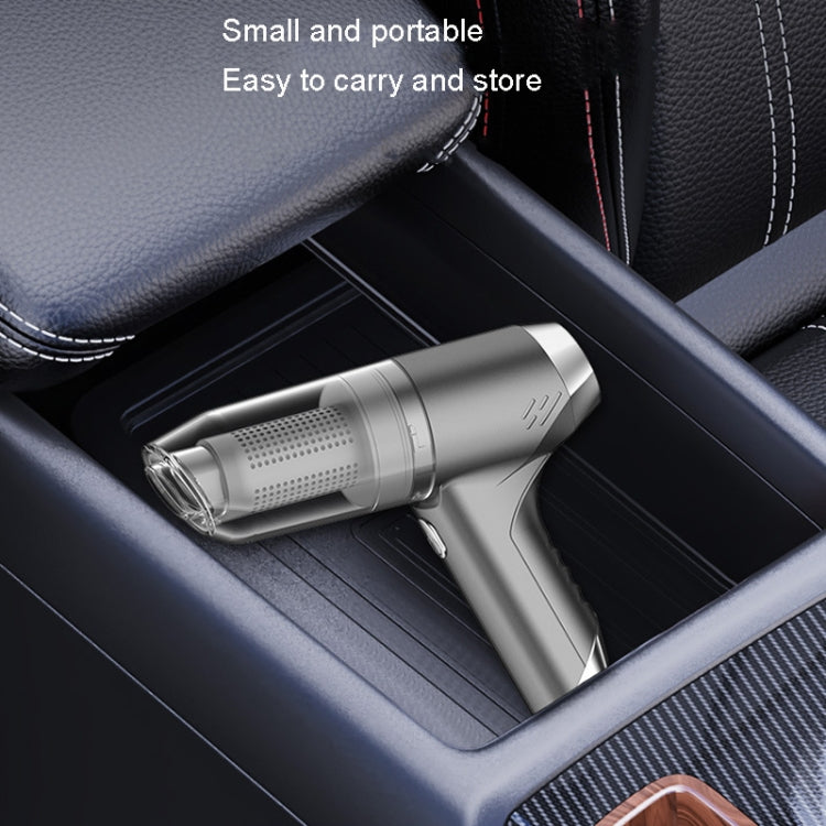 Handheld car vacuum cleaner in silver gray with crevice nozzle on car seat