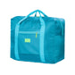 Turquoise portable storage bag with dual handles and front zip pocket for luggage trolley use