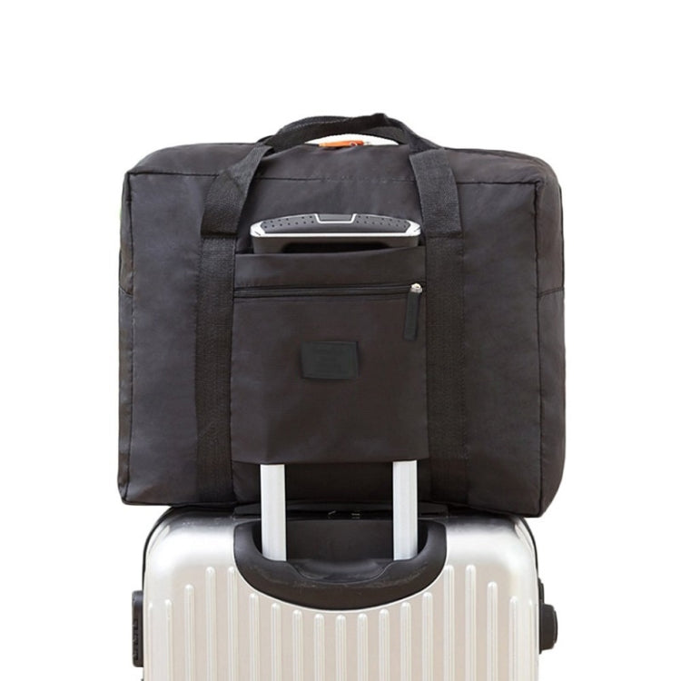 Black trolley storage bag with front zip pocket and top handle, secured over luggage handle