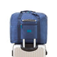 Navy blue trolley storage bag with front zip pocket and wide handles for luggage handle mounting