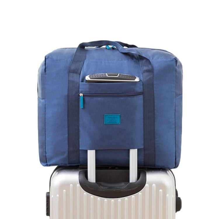 Navy blue trolley storage bag with front zip pocket and wide handles for luggage handle mounting
