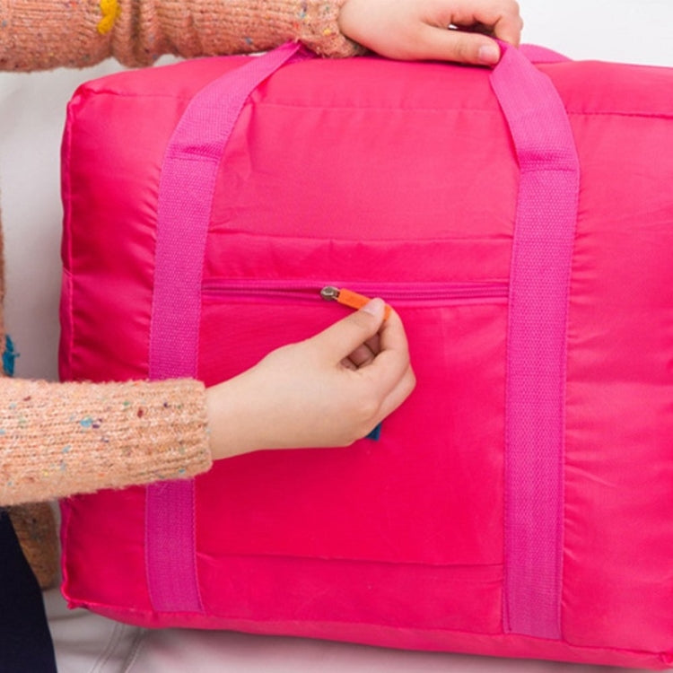 Bright pink trolley storage bag with front zip pocket, zipper being opened by hand