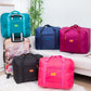 Large-capacity portable storage trolley bag with handles, shown in blue, pink, and black.