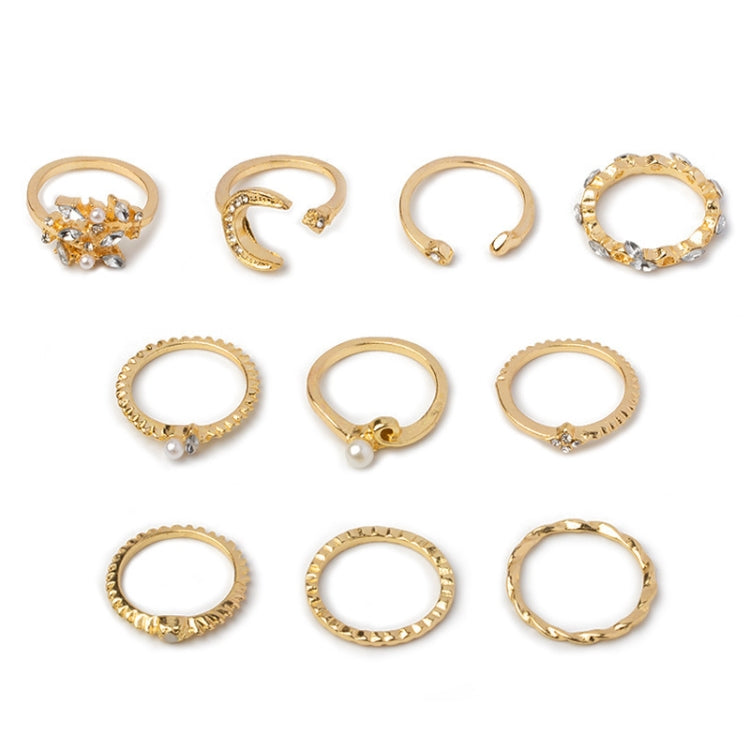 Flat lay of gold-tone knuckle rings with rhinestone moon, star, leaves, heart designs