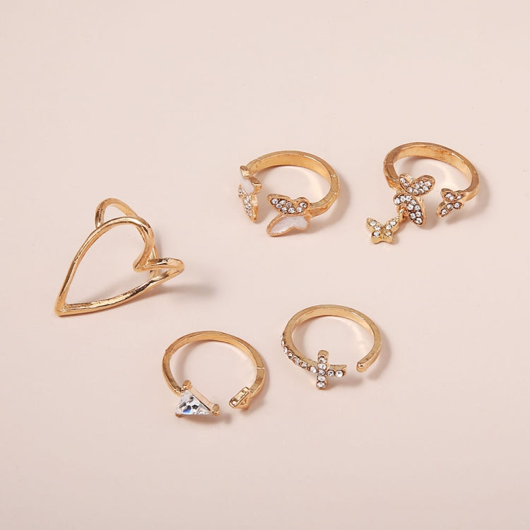 Gold-tone knuckle rings with heart, butterfly, cross, and bow motifs with stones