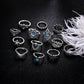 Set of 13 silver-tone rings with blue gemstone details, assorted designs