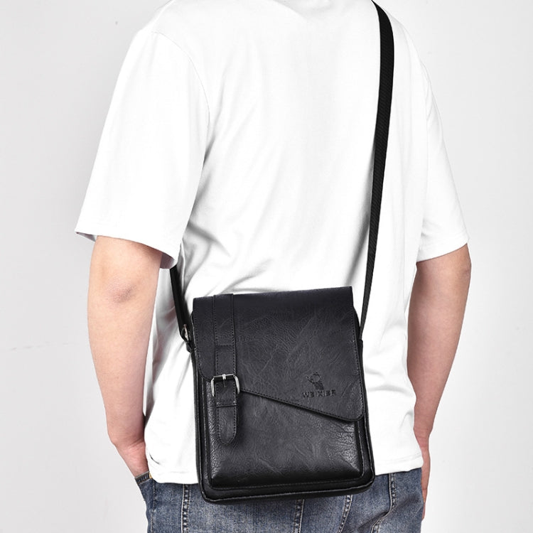 Black vintage crossbody bag worn crossbody with front flap and strap