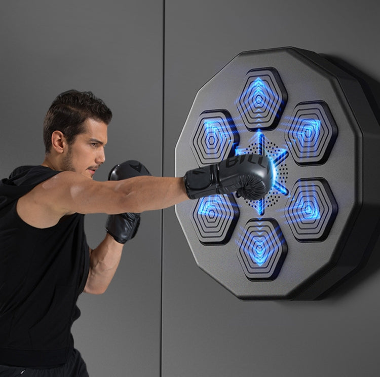 Wall-mounted electronic boxing trainer with blue target lights and boxing glove impact