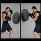 Man practicing boxing hits with black gloves using a wall-mounted electronic trainer