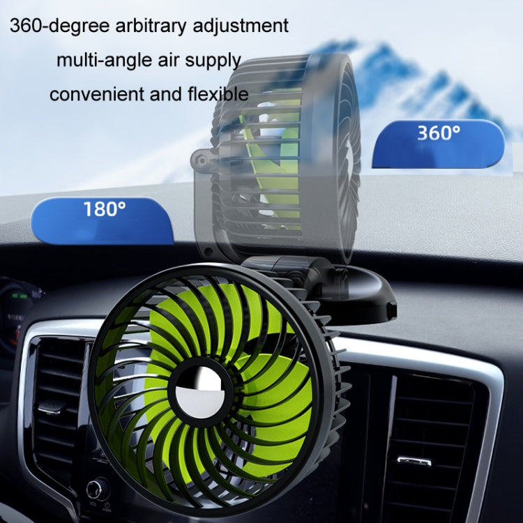 Rotatable car fan with green blades mounted on a dashboard air vent
