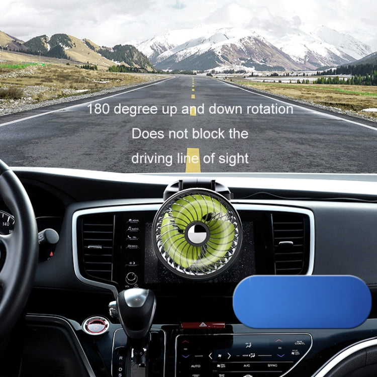 Rotatable car fan with green blades on a dashboard air vent