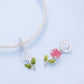 Sterling silver charm bracelet with blue and pink enamel rose beads and green leaves