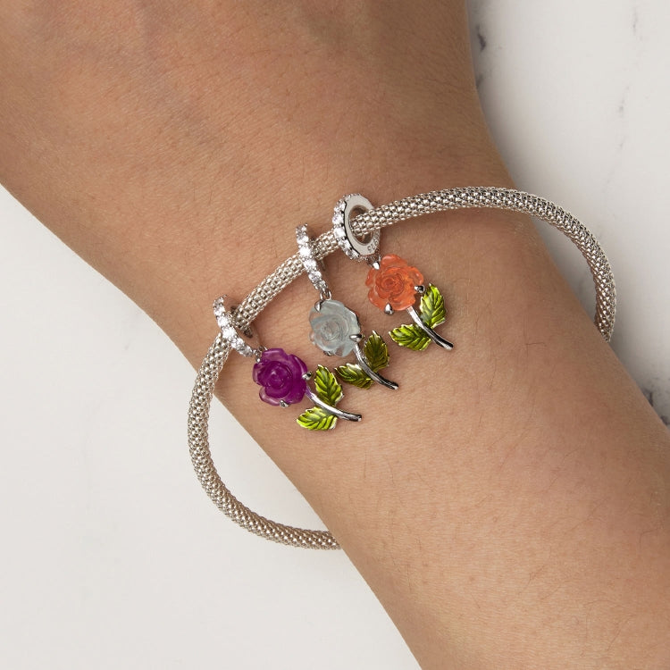 Sterling silver charm bracelet with flower pendants and UV color-changing zircon bead, orange