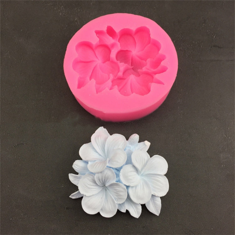Pink silicone 3-petal flower mold with frangipani-style raised blossoms