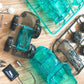 Teal solar engineering vehicle model parts laid out with transparent body panels